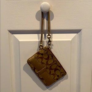 gold coach wristlet. lightly used.